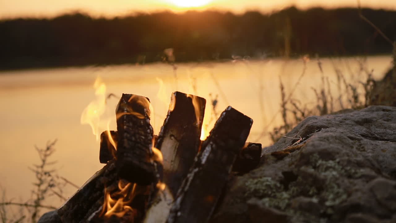 Big Night Bonfire On The Riverbank. Red hot flame of campfire in the evening