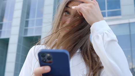 Female-student-checking-phone-and-smiling,-in-slow-motion