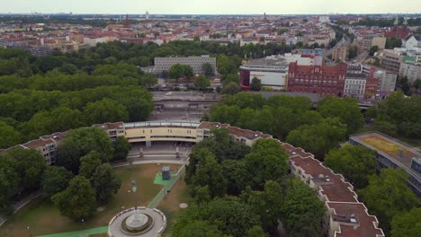 Stunning-aerial-top-view-flight-Ghetto-Building-Mehringplatz-place-city-Berlin-steglitz,-Germany-Summer-day-2023