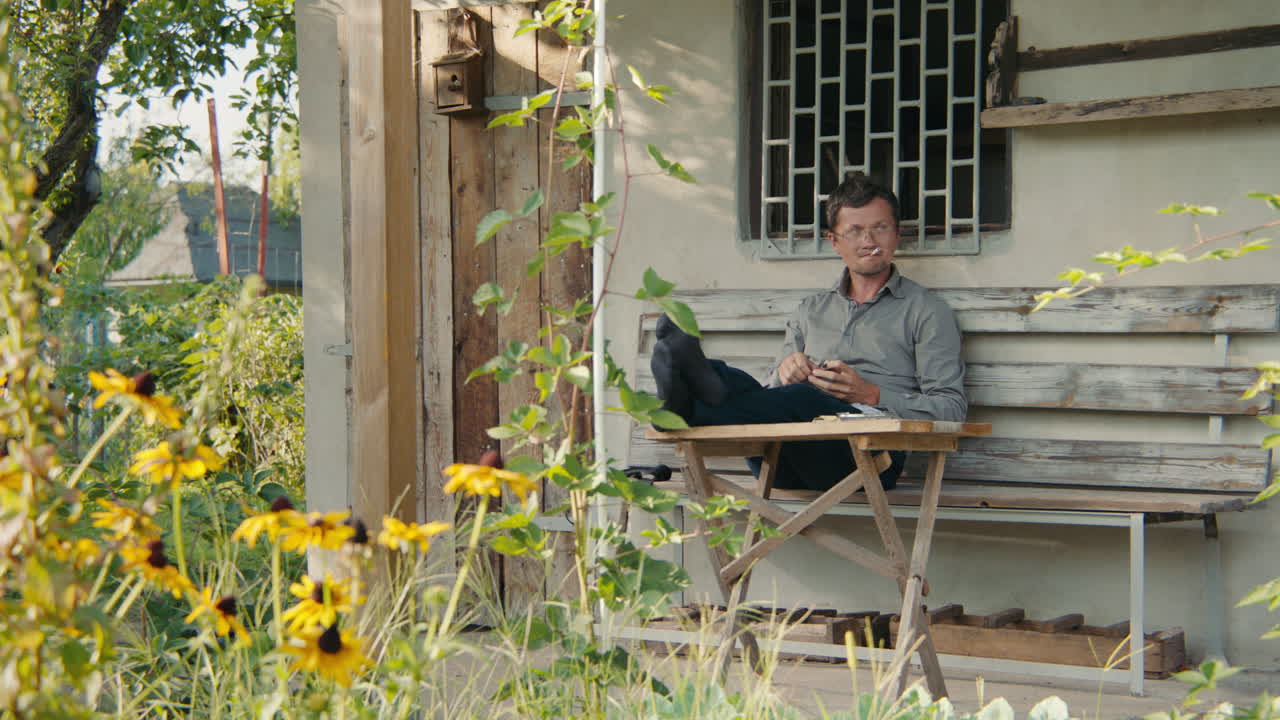 Man relaxing on a porch in a garden