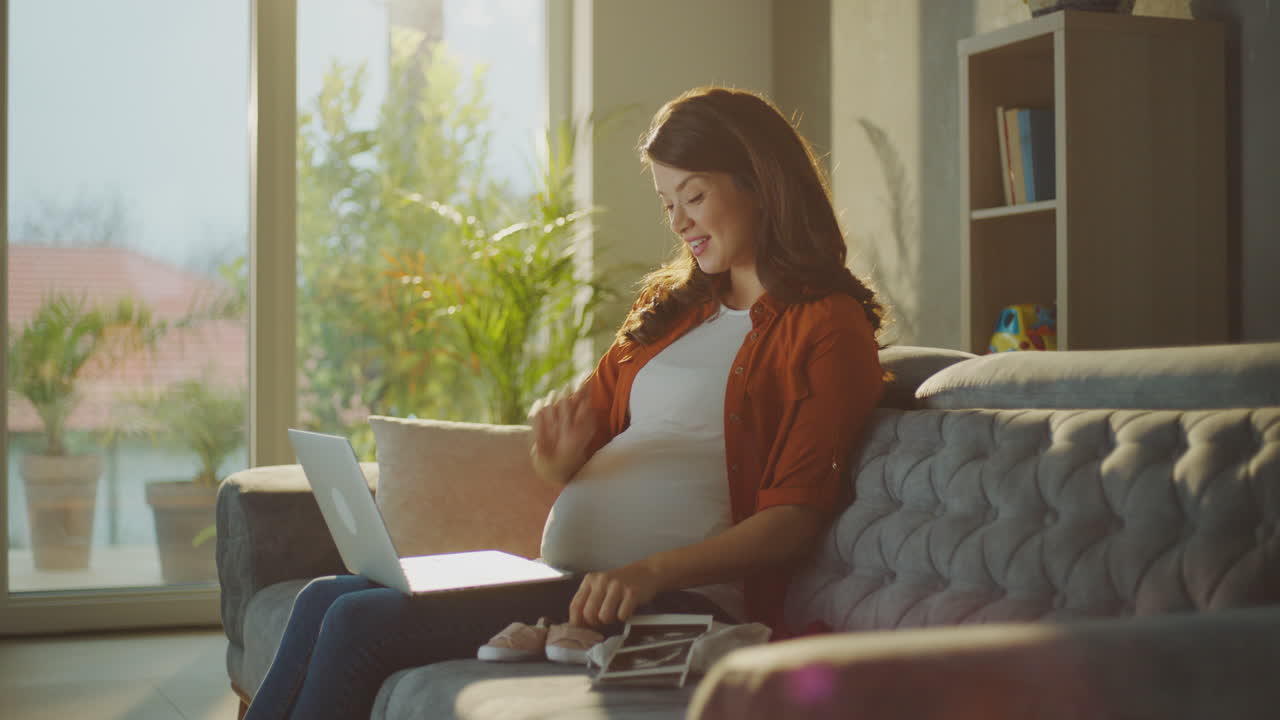 Pregnant Woman Browsing Baby Clothes Online