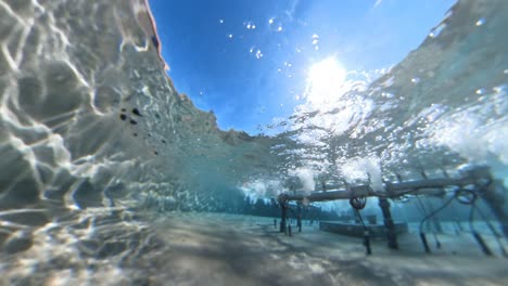 slow motion underwater view of fountain on sunny day