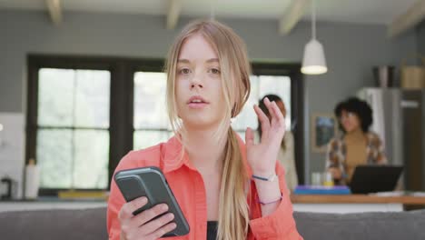 Diverse teenager girls friends having video call on smartphone at home, slow motion
