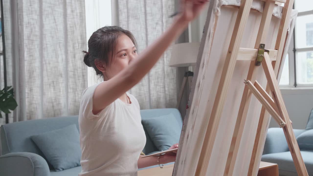 Talented Female Artist Energetically, Enthusiastically Using Paint Brush She Creates With Oil Painting. Creative Studio With Canvas