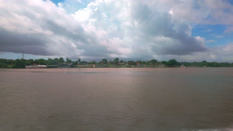 wide river view with distant bank and cloudy sky