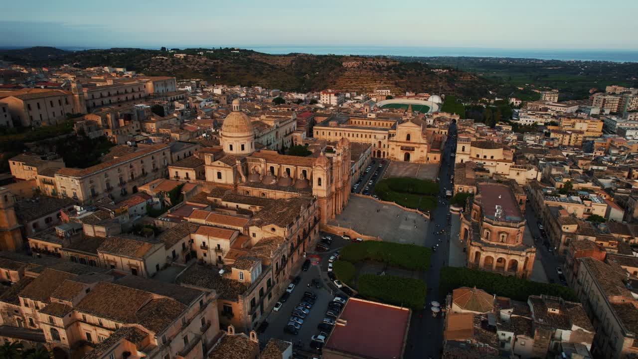 Noto, Sicily at sunset. San Nicolò Cathedral, baroque old town, warm evening light. Aerial drone 4K