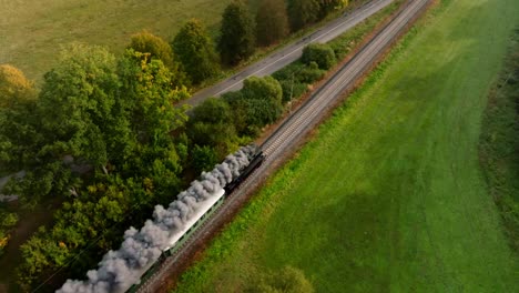 aerial view of a steam train driving in an autumn landscape