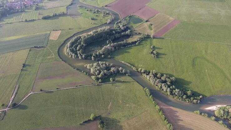 Rural landscape in France. River with fields around, drone view