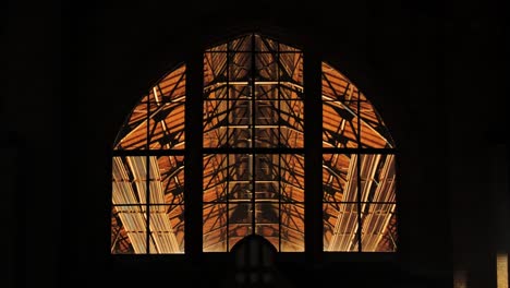 interior lights and ventilation fans glow inside āgenskalns market on dark night