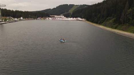 Two-people-out-in-a-paddle-boat-at-beautiufl-adventure-resort-in-Ukraine,-Europe