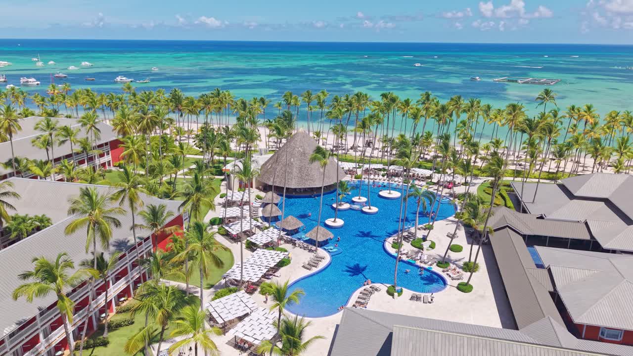 Swimming Pool Of Barcelo Bavaro Hotel With Palm Trees In Summer In Punta Cana, Dominican Republic. - aerial shot