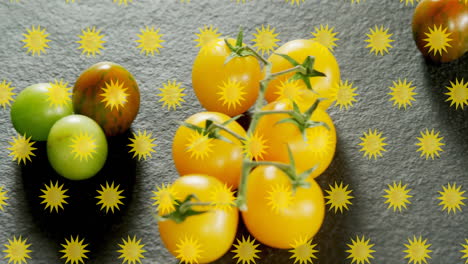 yellow star shapes animation over various tomatoes on dark surface