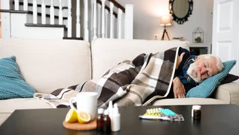 very sick senior man lying on sofa in living room