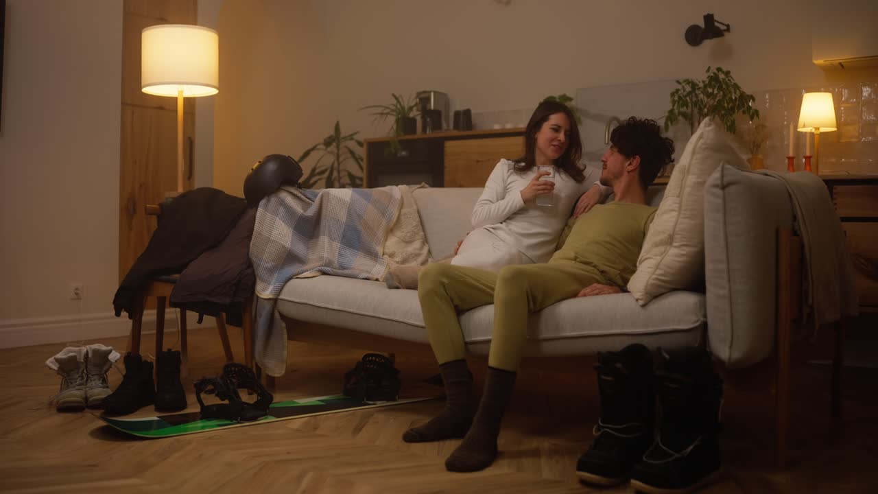 Couple relaxing at home after a ski trip
