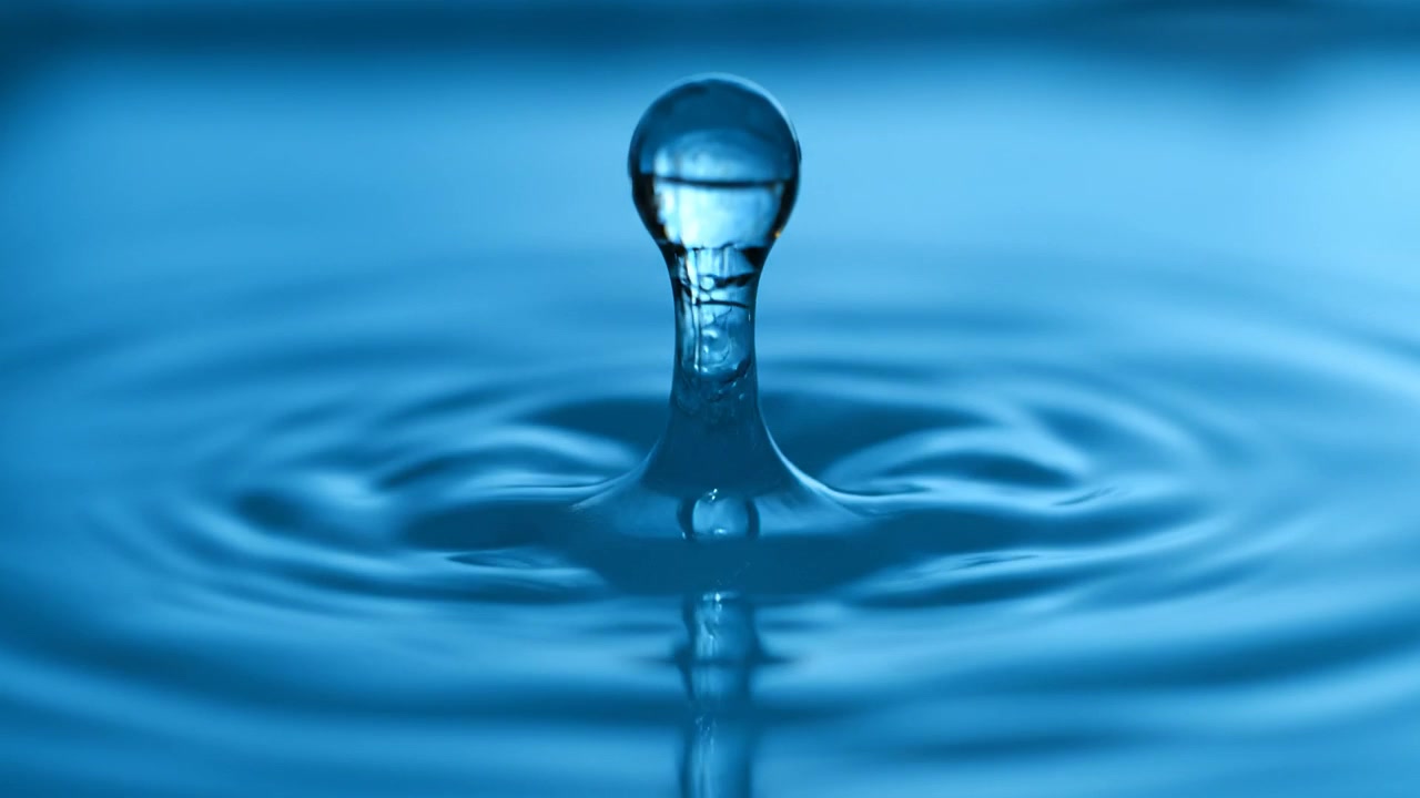 Blue Water Droplet Splashing on Surface with Ripples