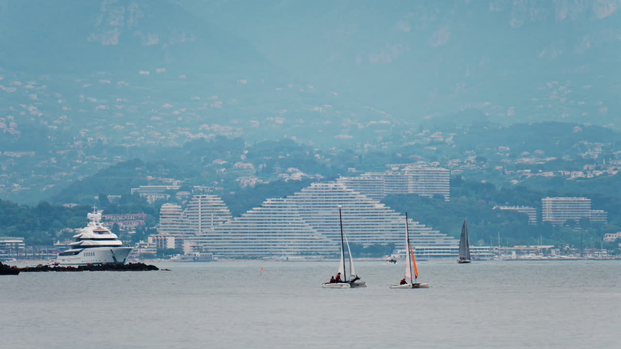 Distant view of multiple boats moving near the Marina Baie des Anges in Villeneuve-Loubet, France