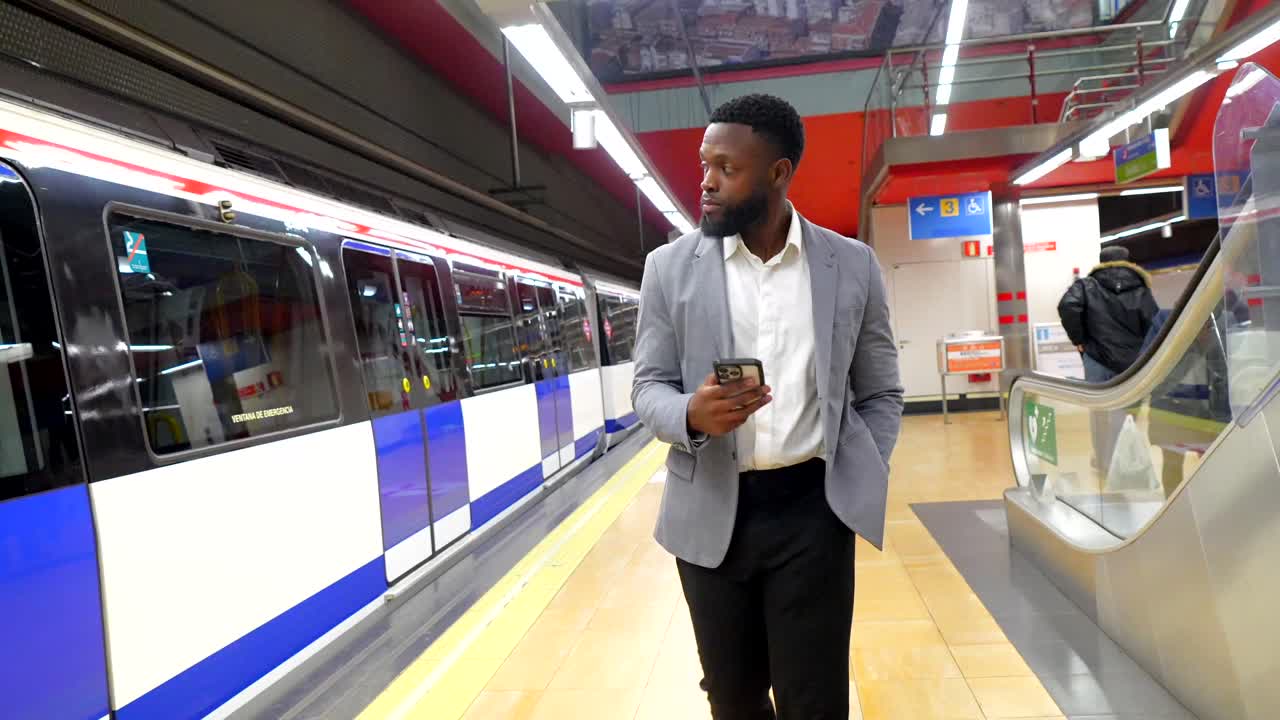 Man using smartphone in subway station