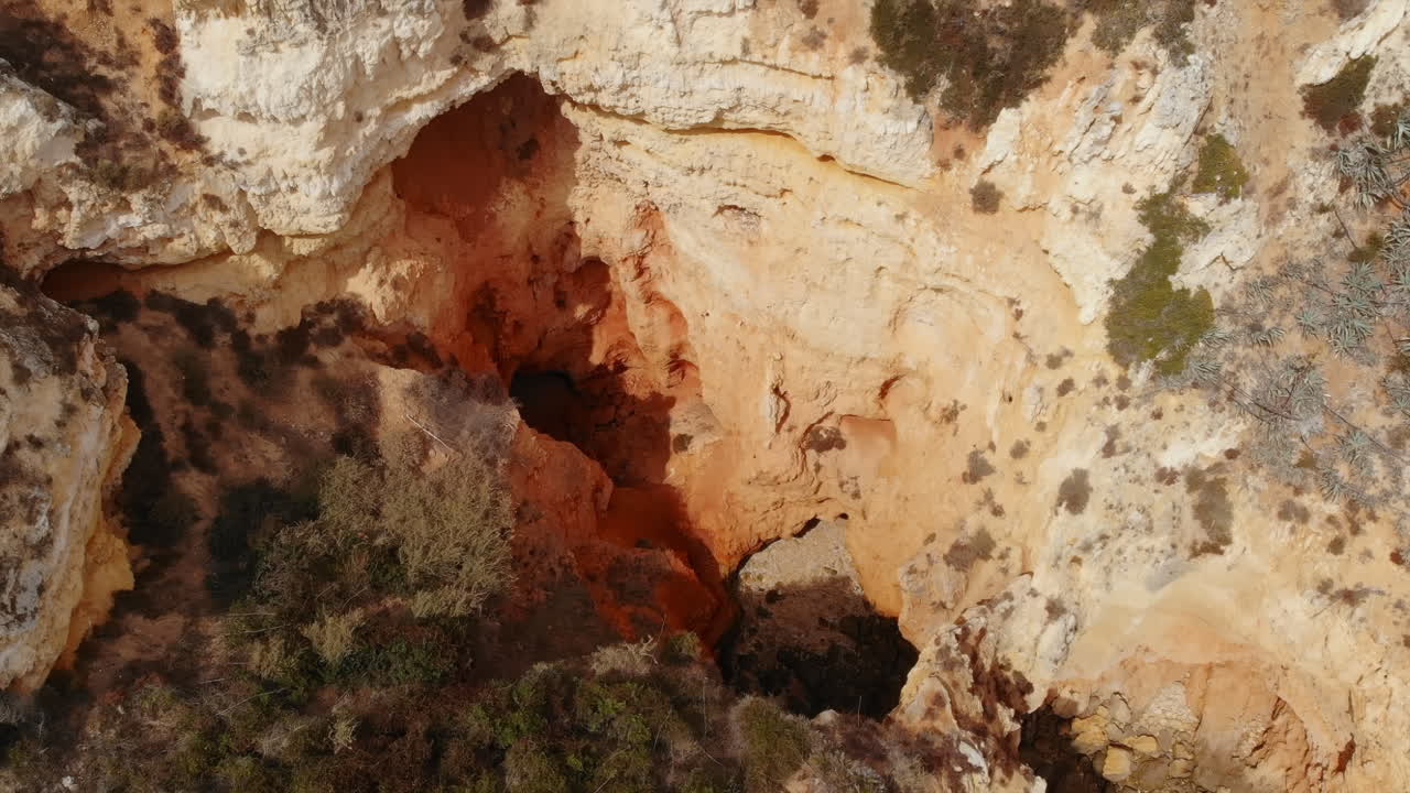 Aerial view of a canyon with rock formations and vegetation