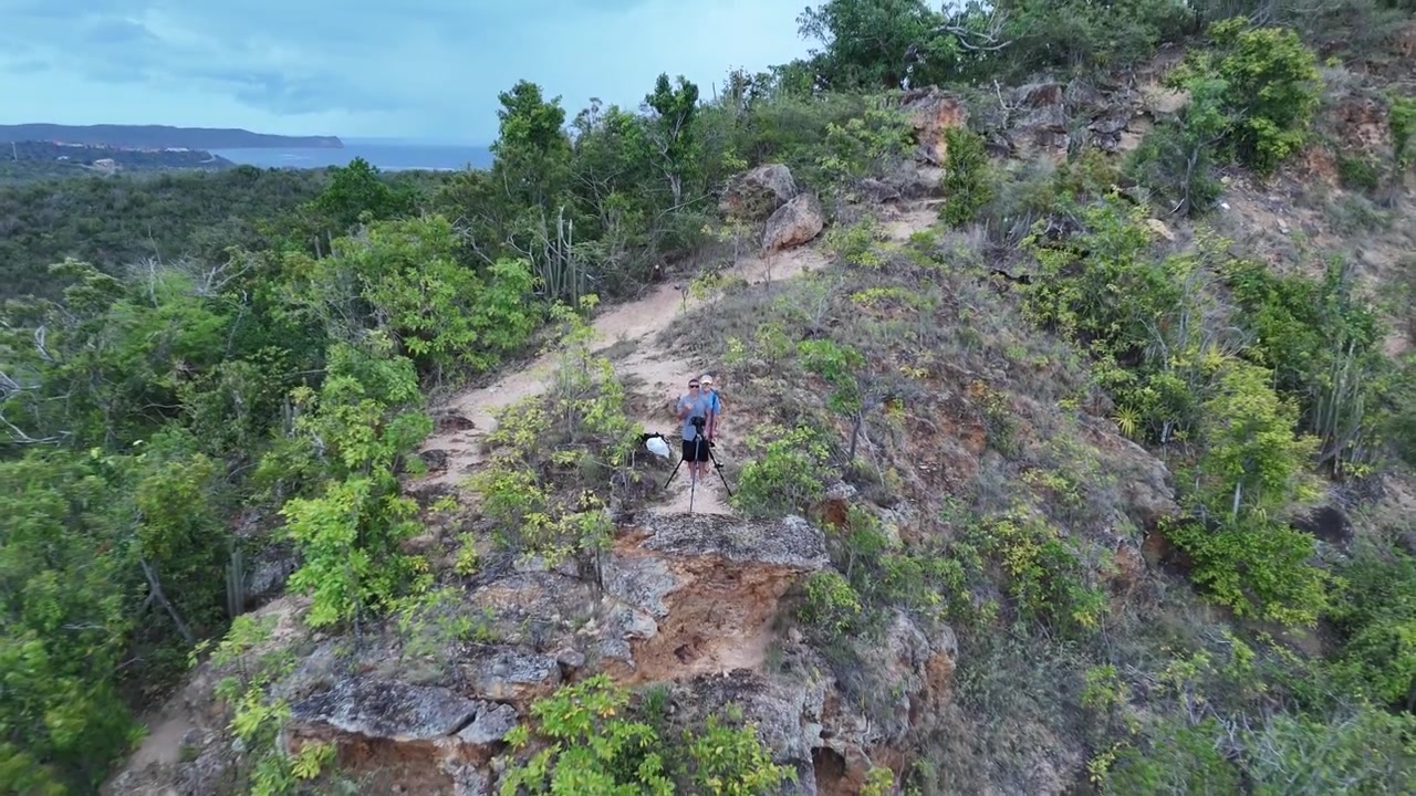 Turisti che operano un drone al Shirley Heights Lookout ad Antigua e Barbuda - Ripresa aerea in allontanamento