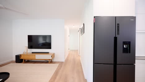 long sweeping push thought from modern open plan living room down hallway into small contemporary bedroom