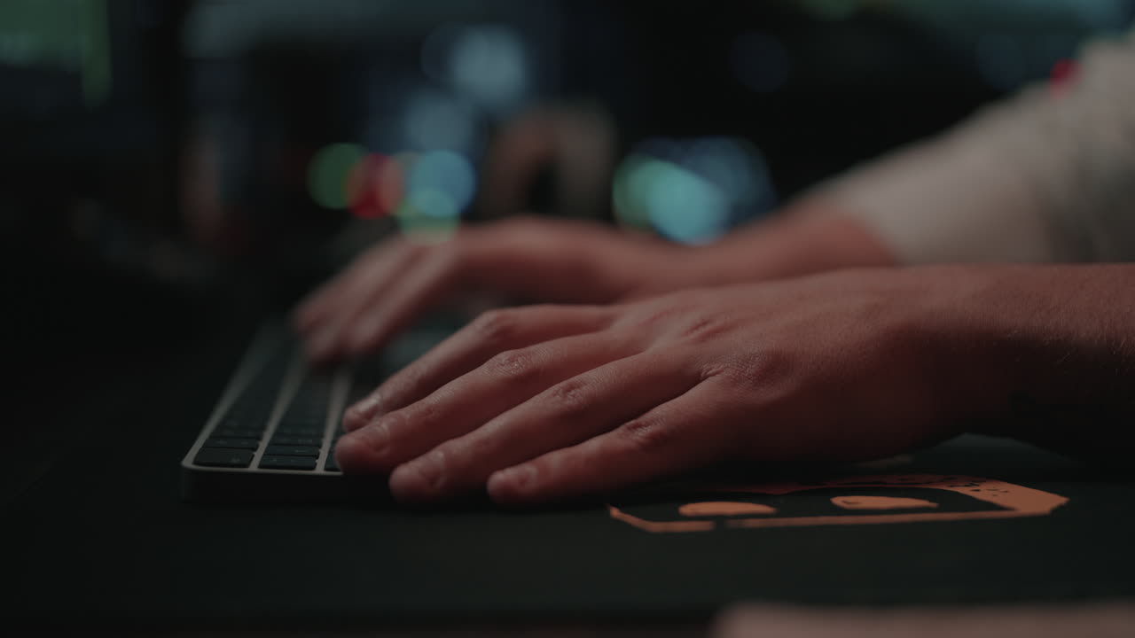Person Typing on a Keyboard at Night