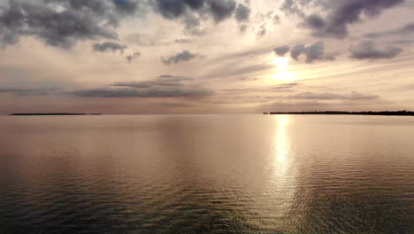 aerial rising footage of sunset over wild fowl bay in michigan in the summer