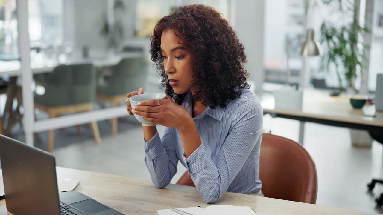 A woman taking a break with coffee in the office