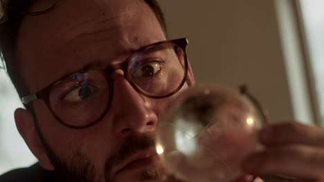 man looking through a crystal ball