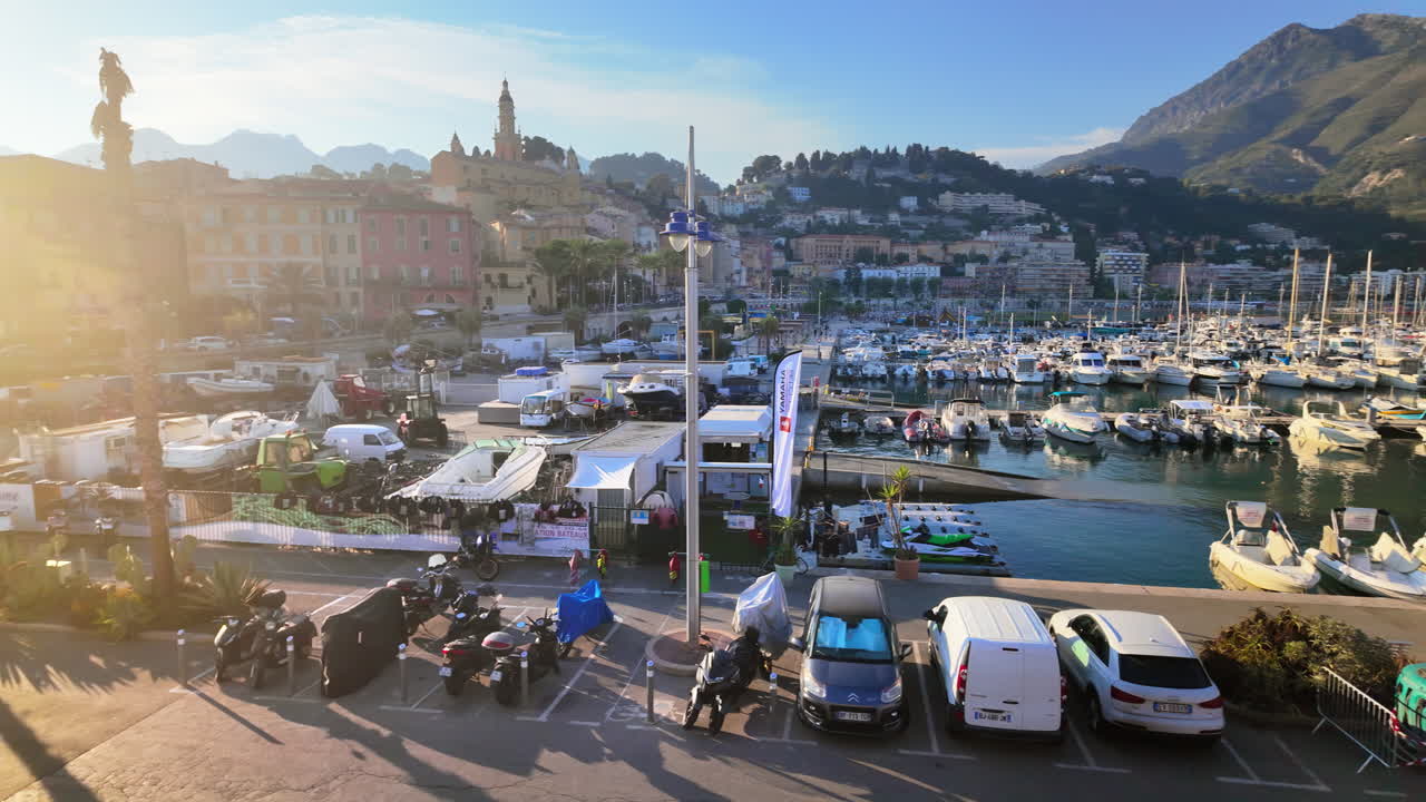 View of boats docked in the Port de Menton in the French Riviera with the colourful buildings in the background