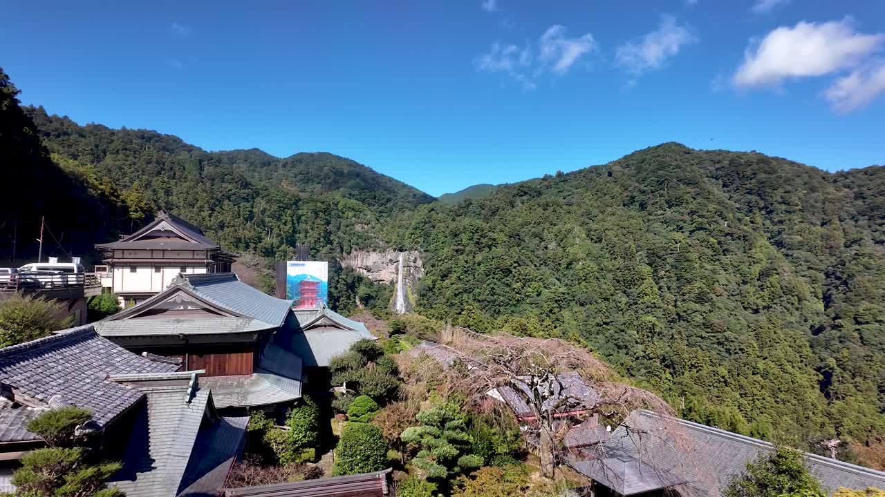 Scenic view of Nachisan Mountain with a stunning waterfall in Wakayama, surrounded by traditional Japanese architecture and lush greenery
