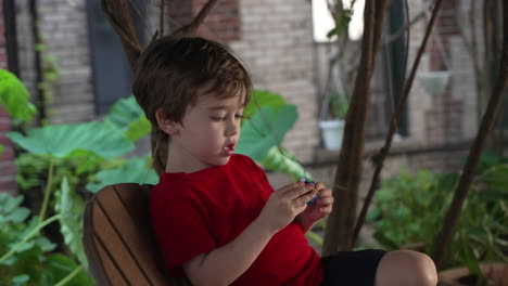 isolated little boy playing with a rubik's cube, caucasian kid portrait