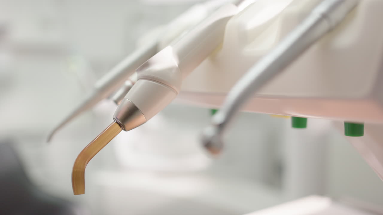 Dentist choose stainless steel tool to use for oral examination, shallow focus