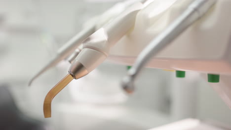 dentist choose stainless steel tool to use for oral examination, shallow focus