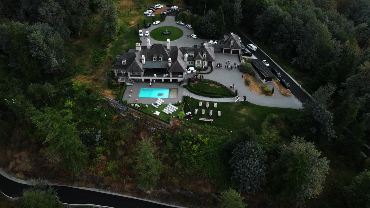 Wide drone shot of wedding venue at a winery during ceremony preparation
