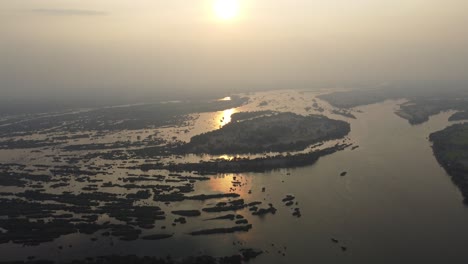 a magical sunset over the mekong river, the so called 4000 islands in the south of laos