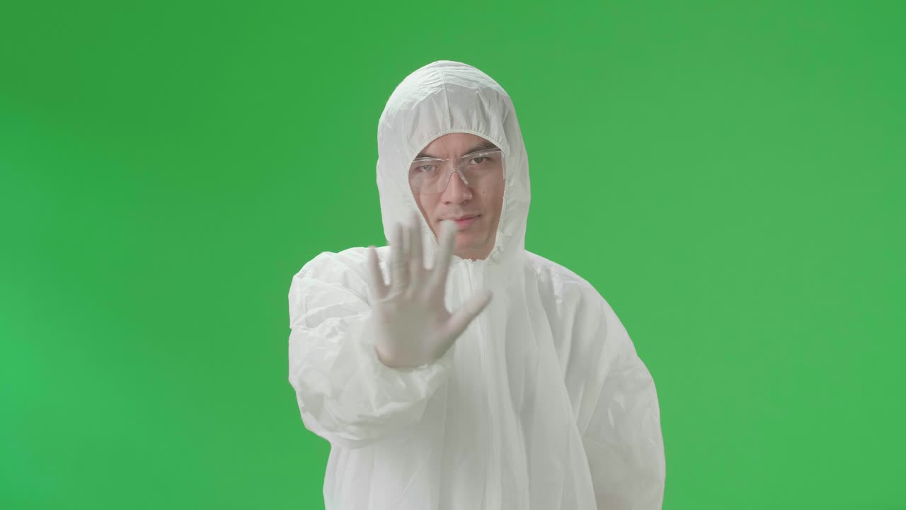 Person in Protective Gear Giving Stop Sign