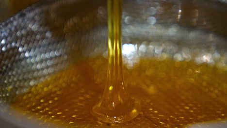 honey pouring into strainer