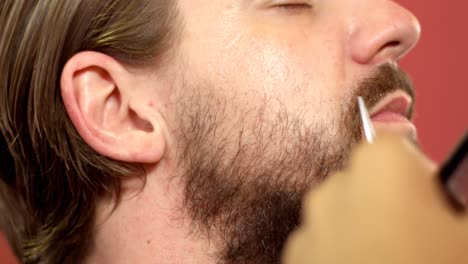 Man-getting-his-mustache-trimmed-in-hair-salon-4k