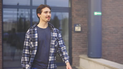 man walking outside building and delivery person