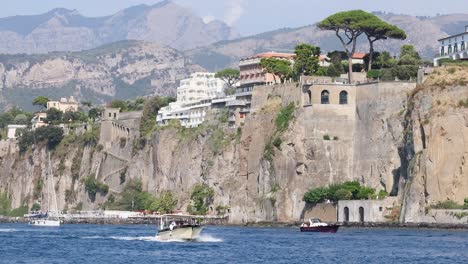 boat travels along scenic cliffs in sorrento