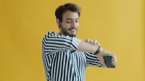 man dancing with phone and headphones