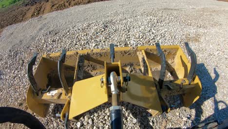 box scrapper leveling on a new graveled driveway, tractor making large loop