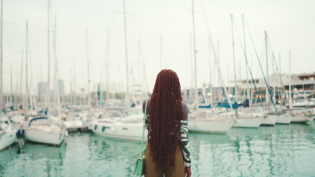Woman at a marina with yachts