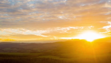 Beautiful-altocumulus-clouds-rolling-over-the-peaceful-mountain-village-of-Poland-during-sunset---time-lapse