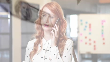 Talking on smartphone, red-haired woman in office with animated background