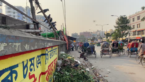 dhaka street traffic and piles of garbages on side, handheld view