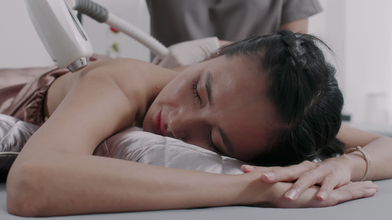 Woman Having Her Back Hair Removed with Laser during Procedure