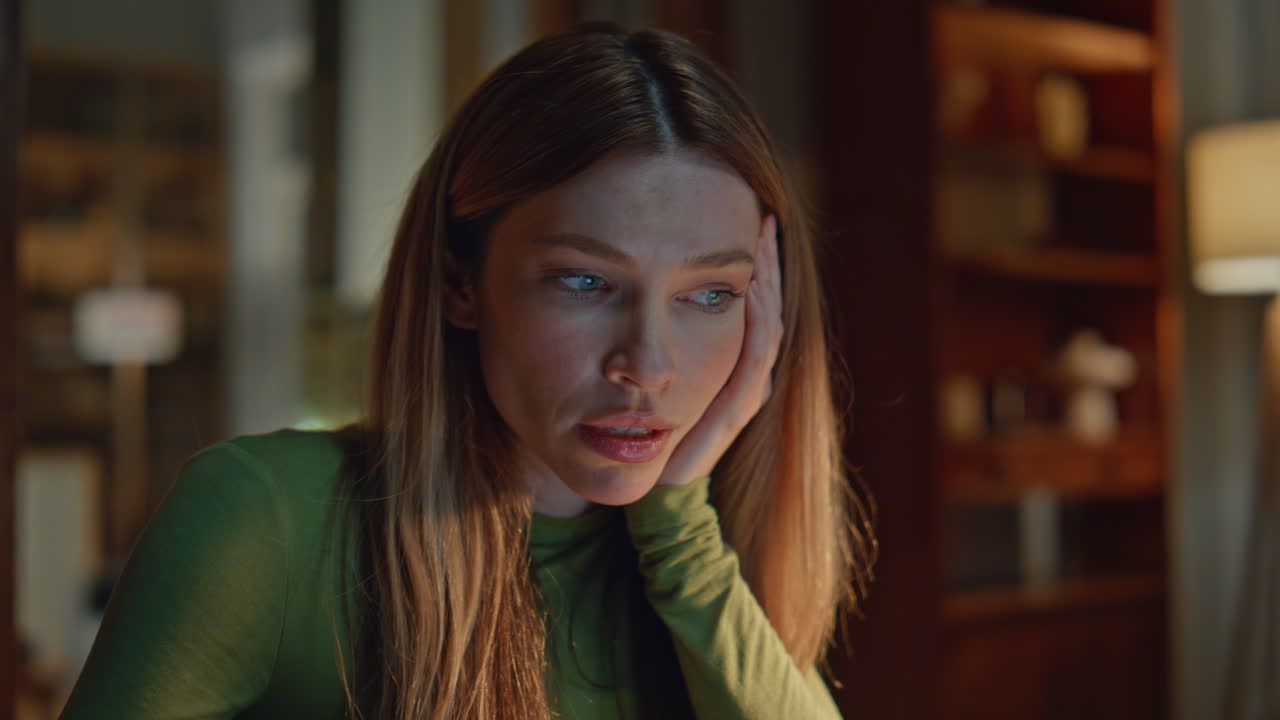 Unmotivated girl working late looking laptop close up. Tired woman sitting dark