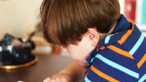 Boy-using-digital-tablet-in-living-room-4k