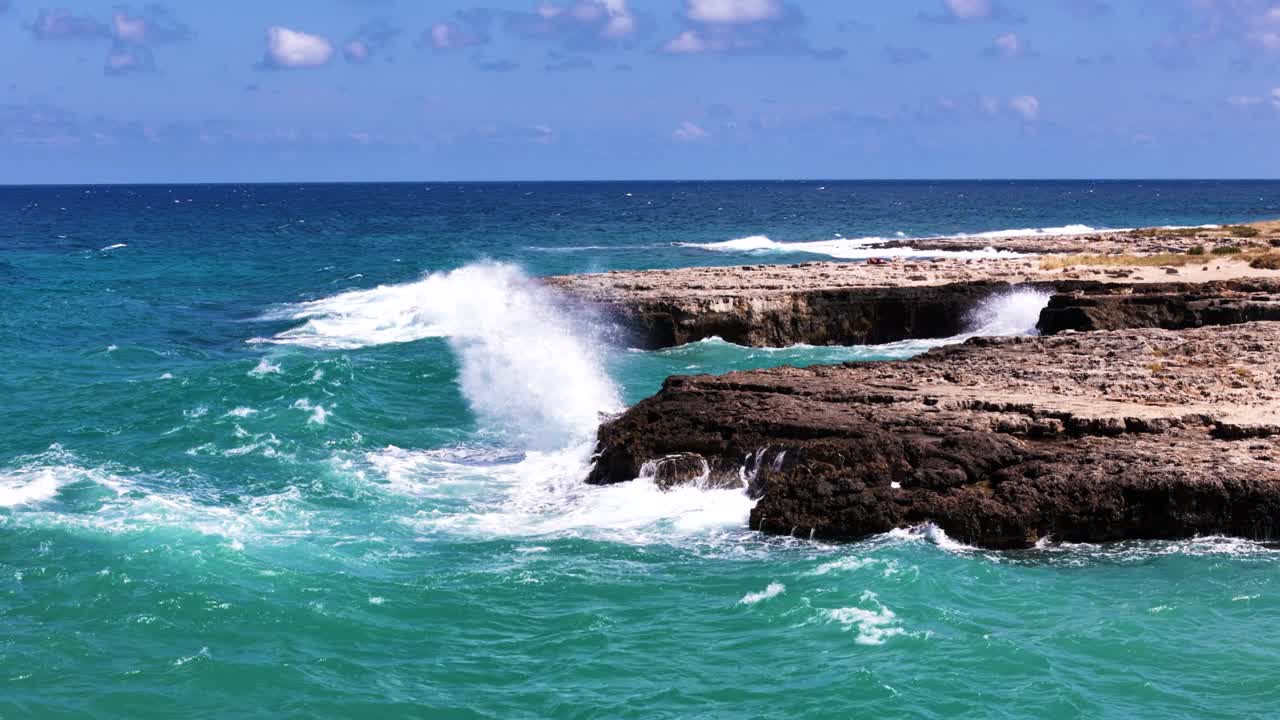 Powerful waves hit rocky shore, side static view